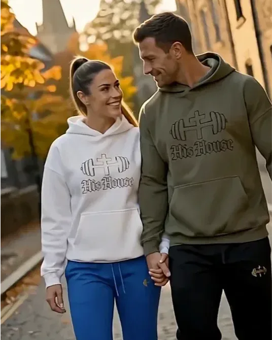 Couple wearing matching His House hoodies outdoors
